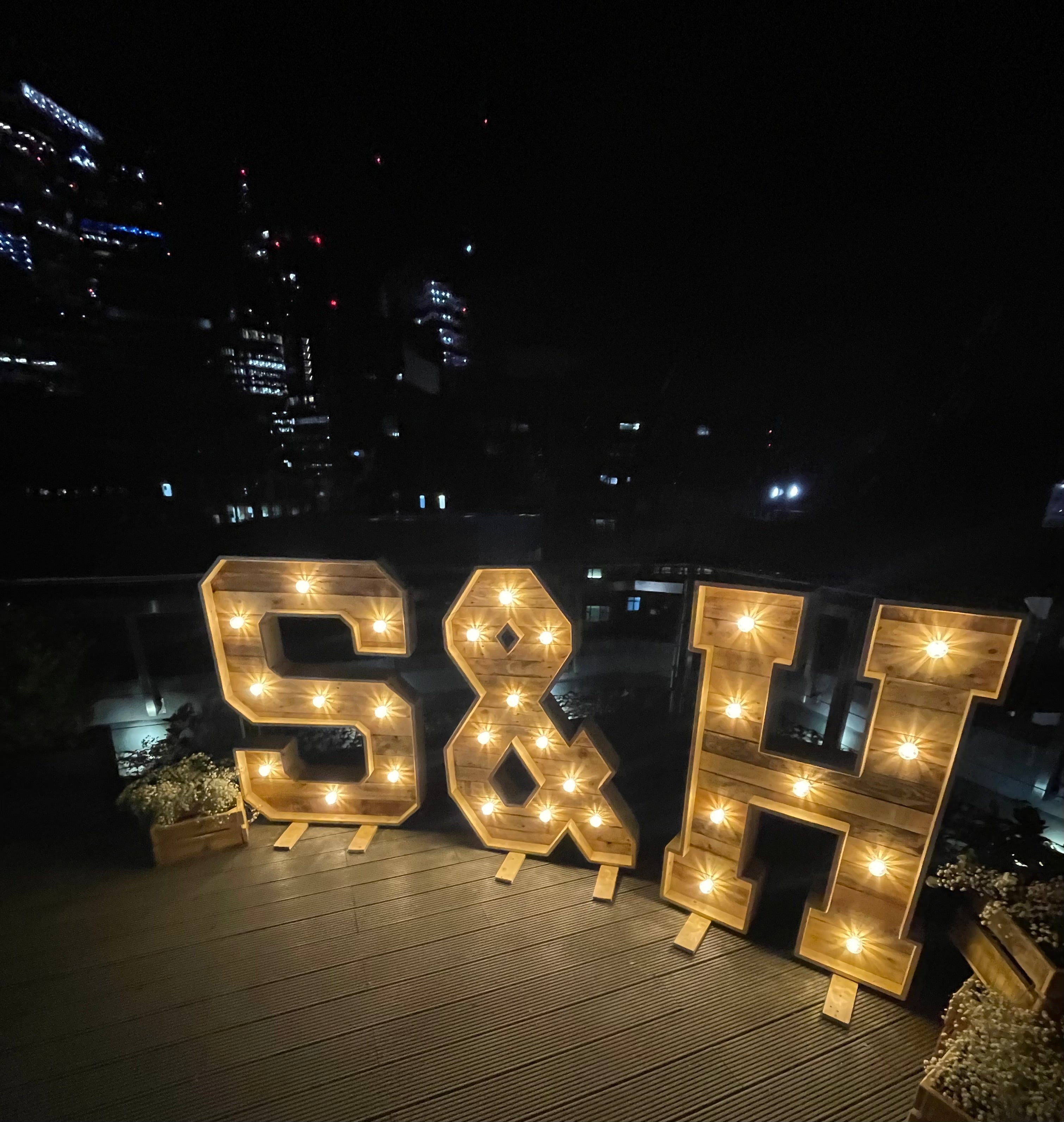 Wood-letter-with-lights-decor-on-wooden-deck-for-https://www.james2.co.uk/-night-shot